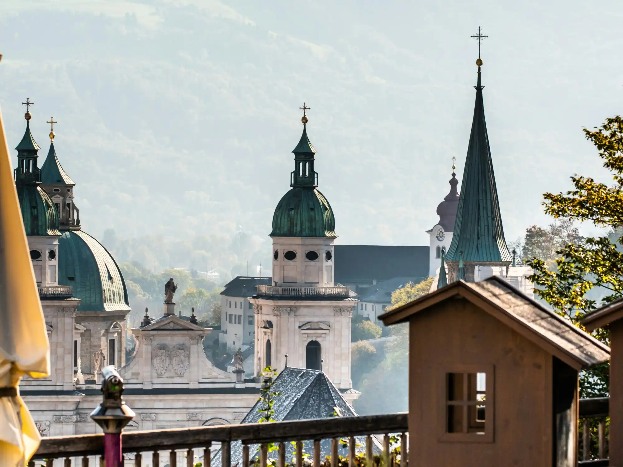 An outdoor pool with lounge chairs, beige sun umbrellas, with an infinity view of the Caribbean Sea.