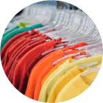 rack of brightly coloured t-shirts, image.