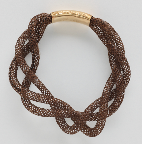 A brown woven bracelet with a gold bandAI-generated content may be incorrect.