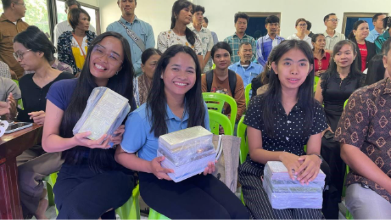 A group of women holding boxesAI-generated content may be incorrect.