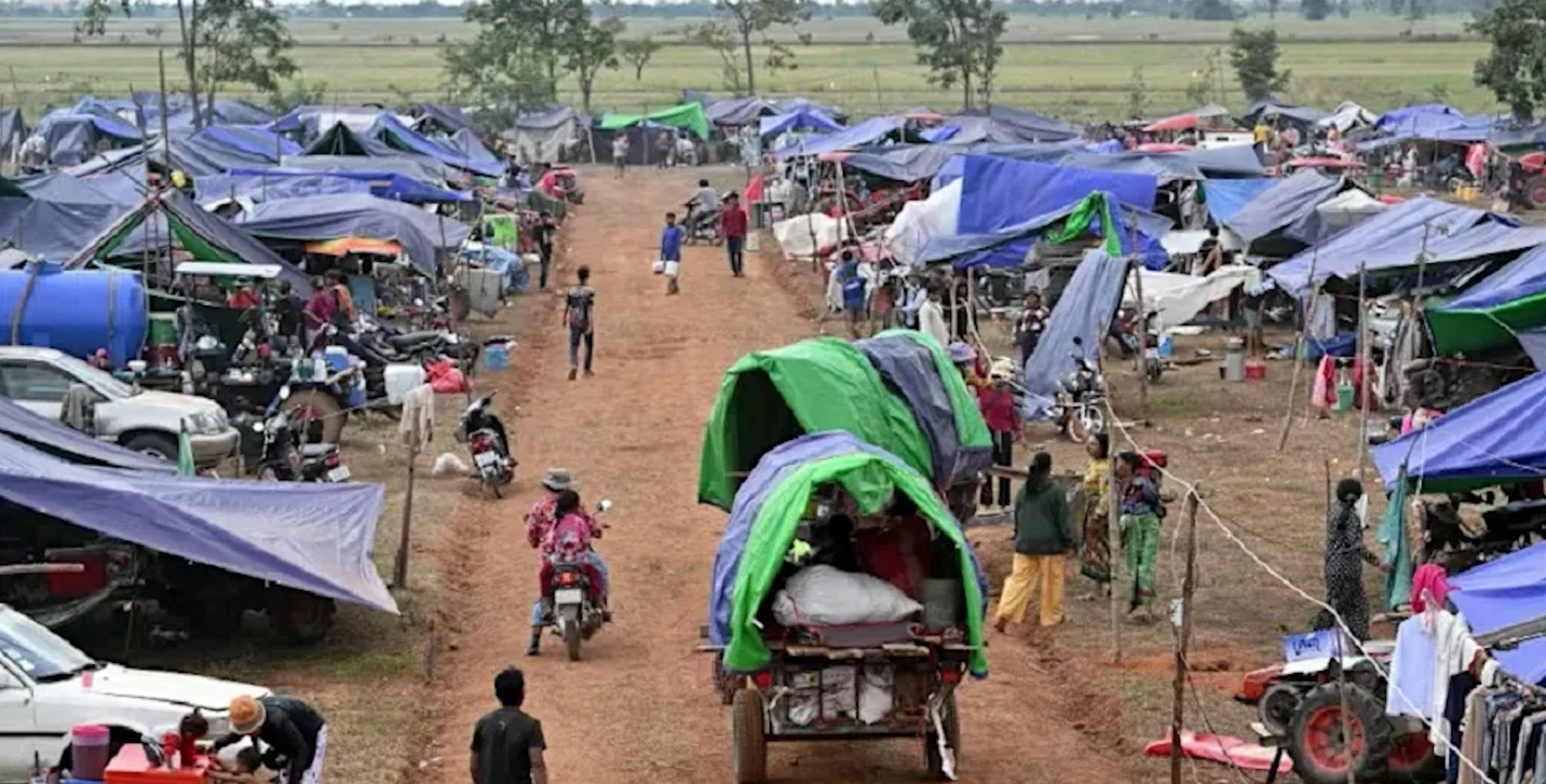 A group of people on a dirt road with tentsAI-generated content may be incorrect.