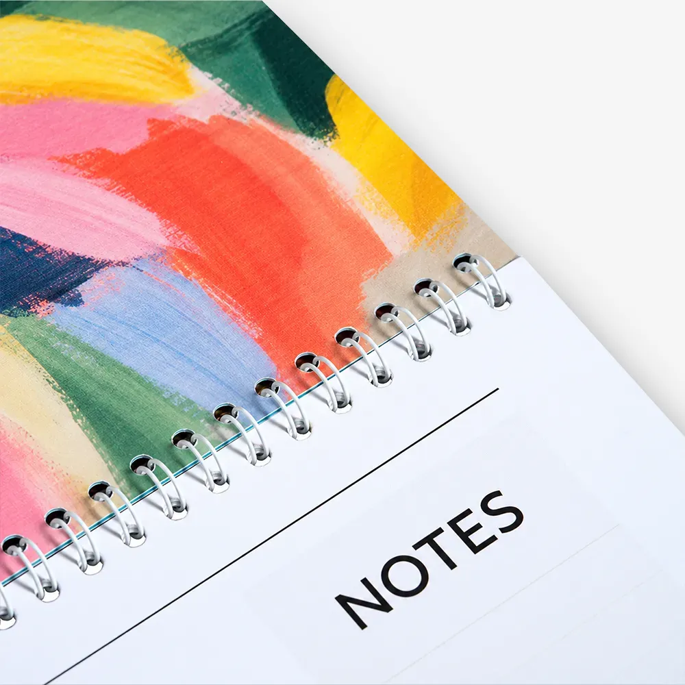A calendar on a table with other items
