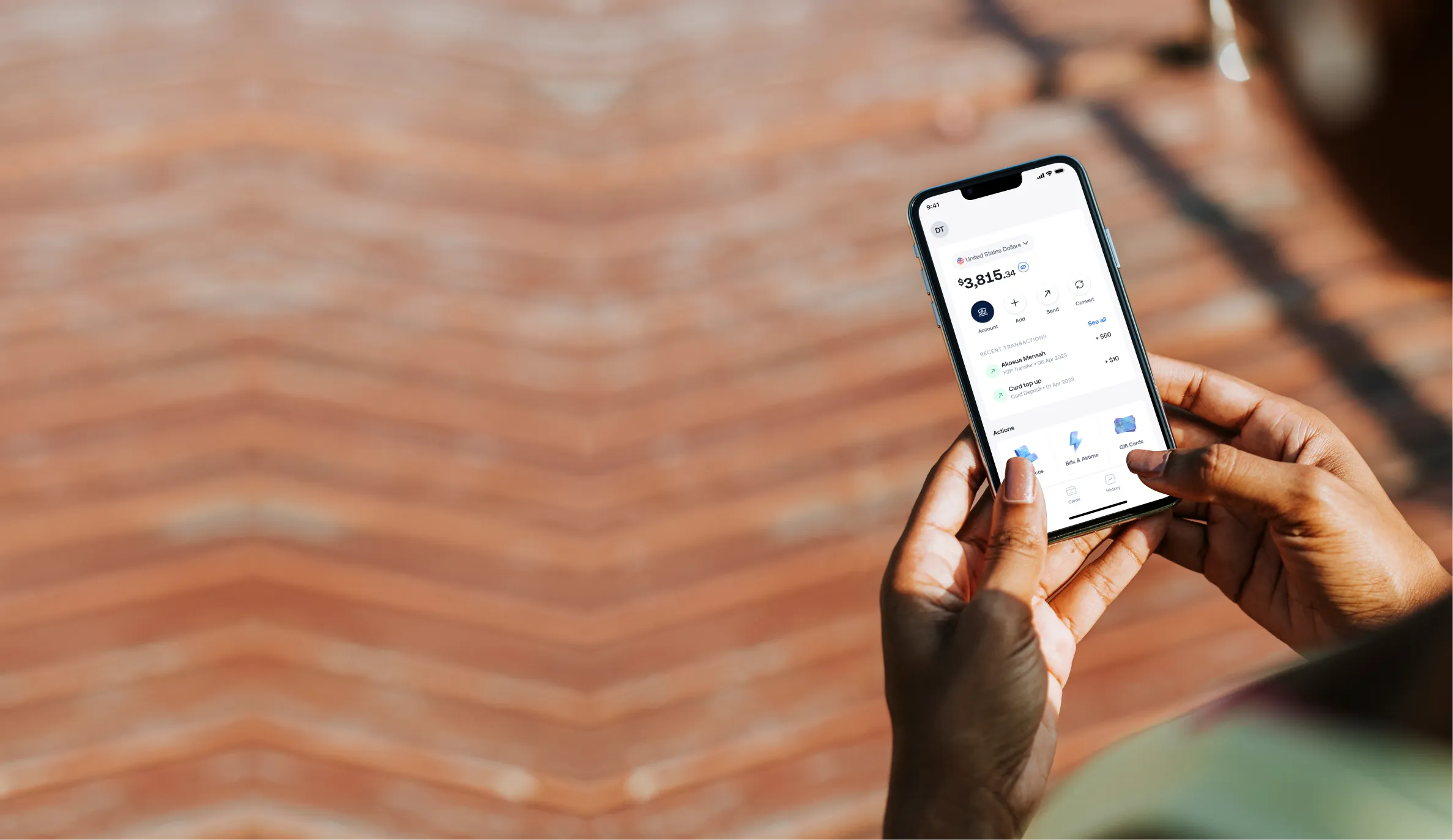 Person holding a smartphone showing a financial app with a $3,815 account balance and recent transactions.