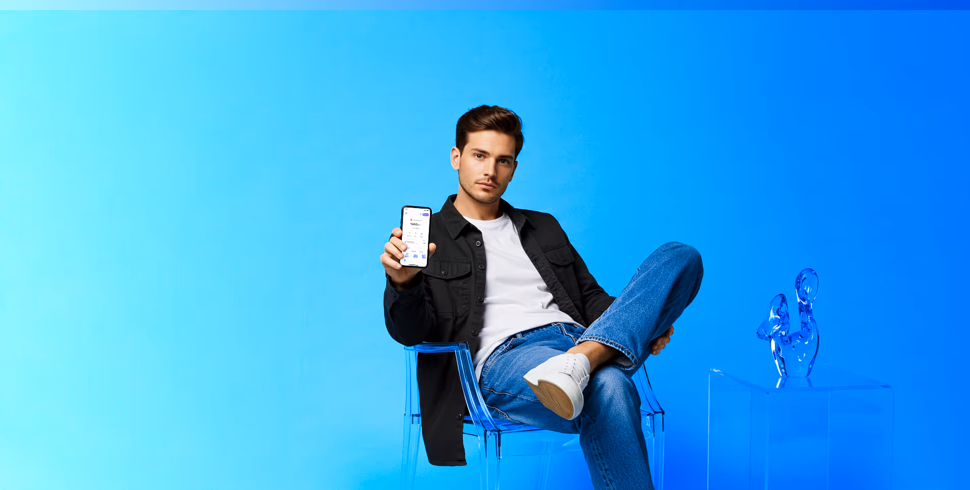 Man sitting on clear chair holding phone showing an app screen against a blue background.