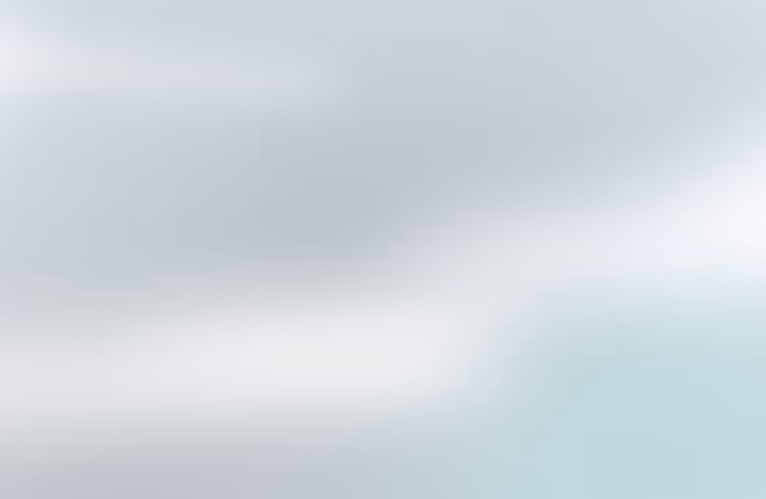 A teal and white gradient background