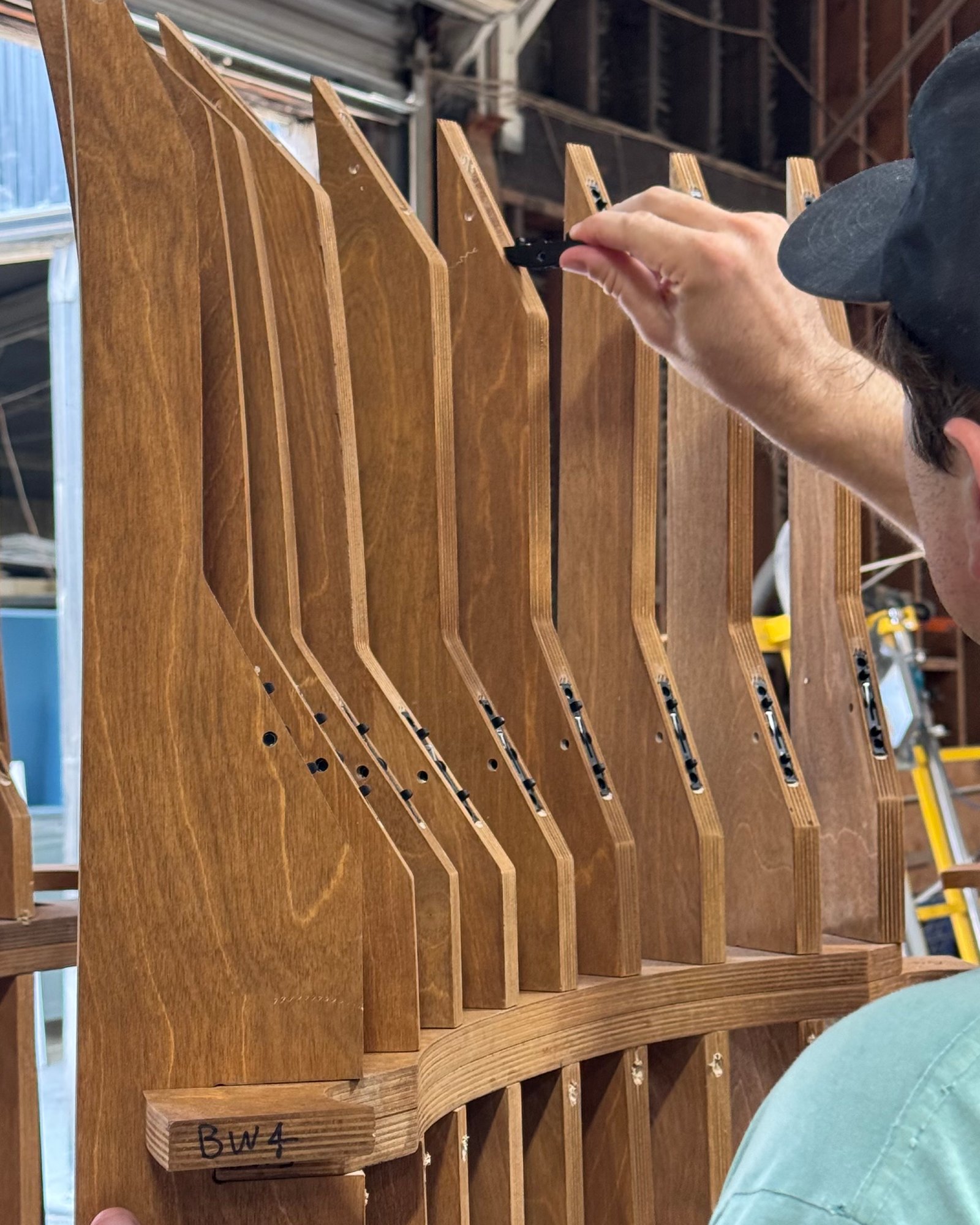 Fitting curved plywood ribs during assembly in the Calico shop