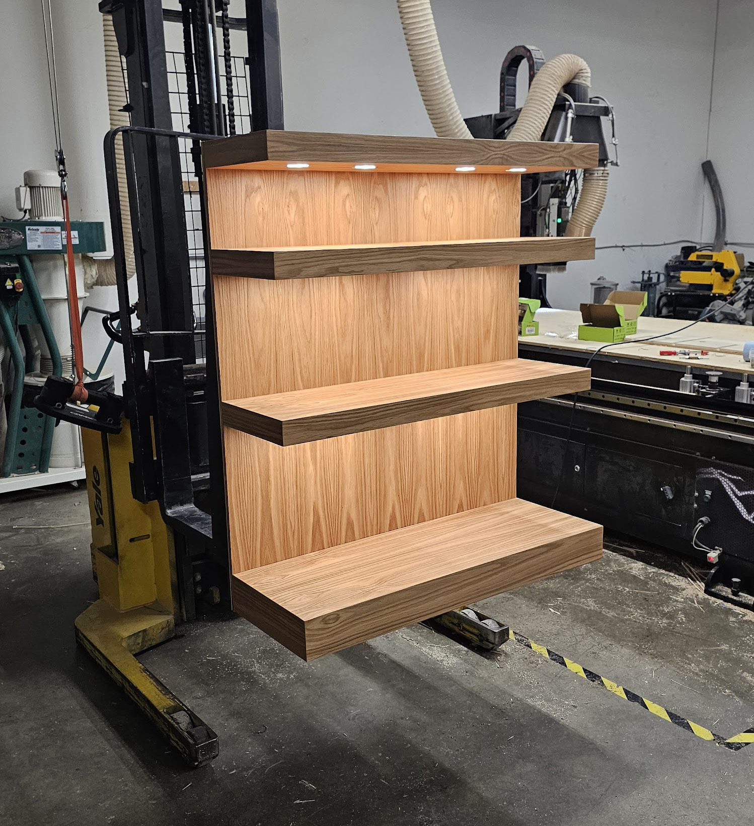 Walnut-veneered display fixture with lit shelves in the Calico shop