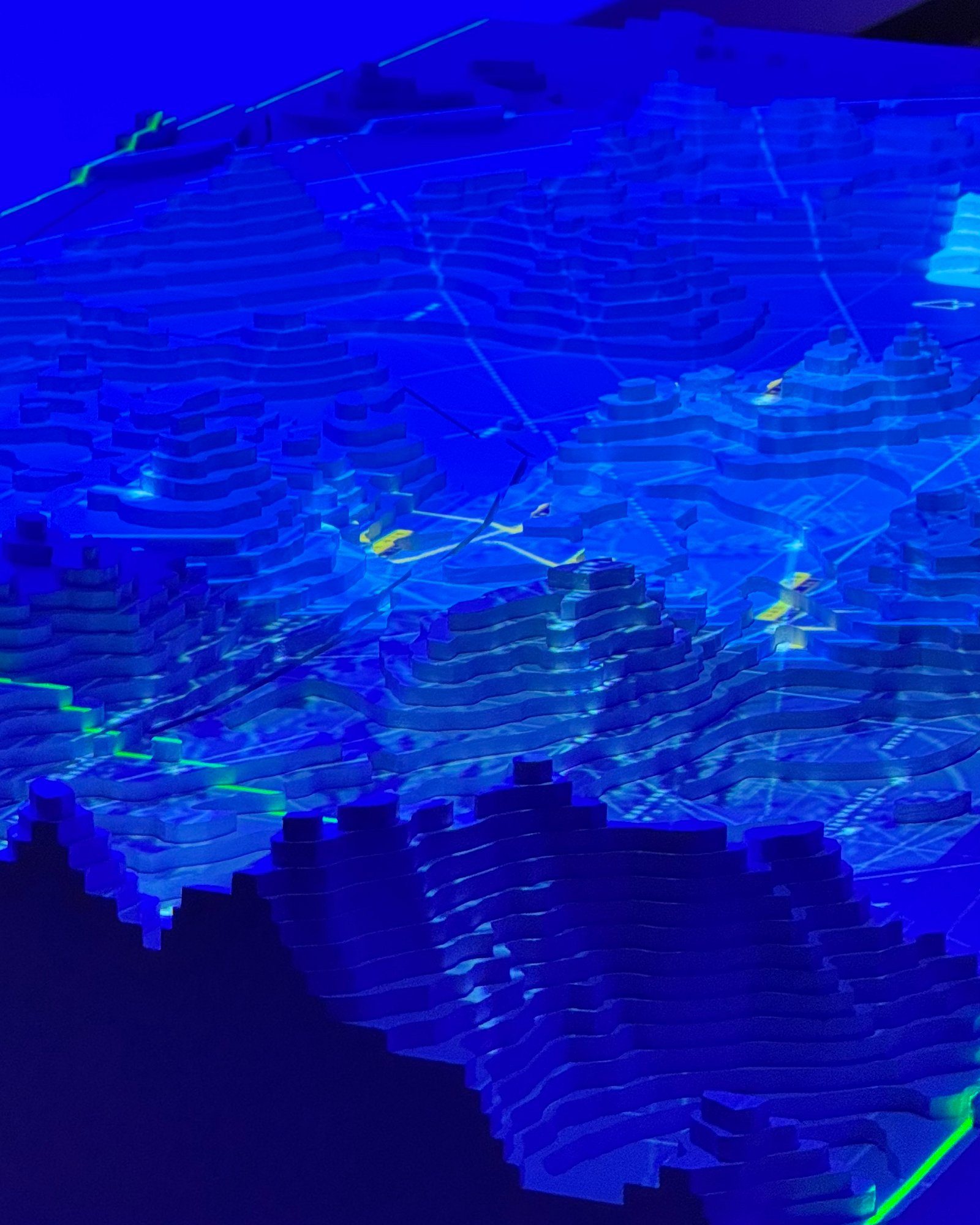Layered terrain model lit with blue light