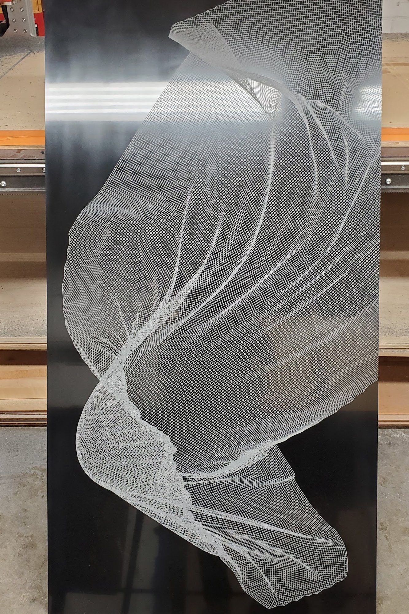 Etched aluminum panel with a flowing drapery pattern