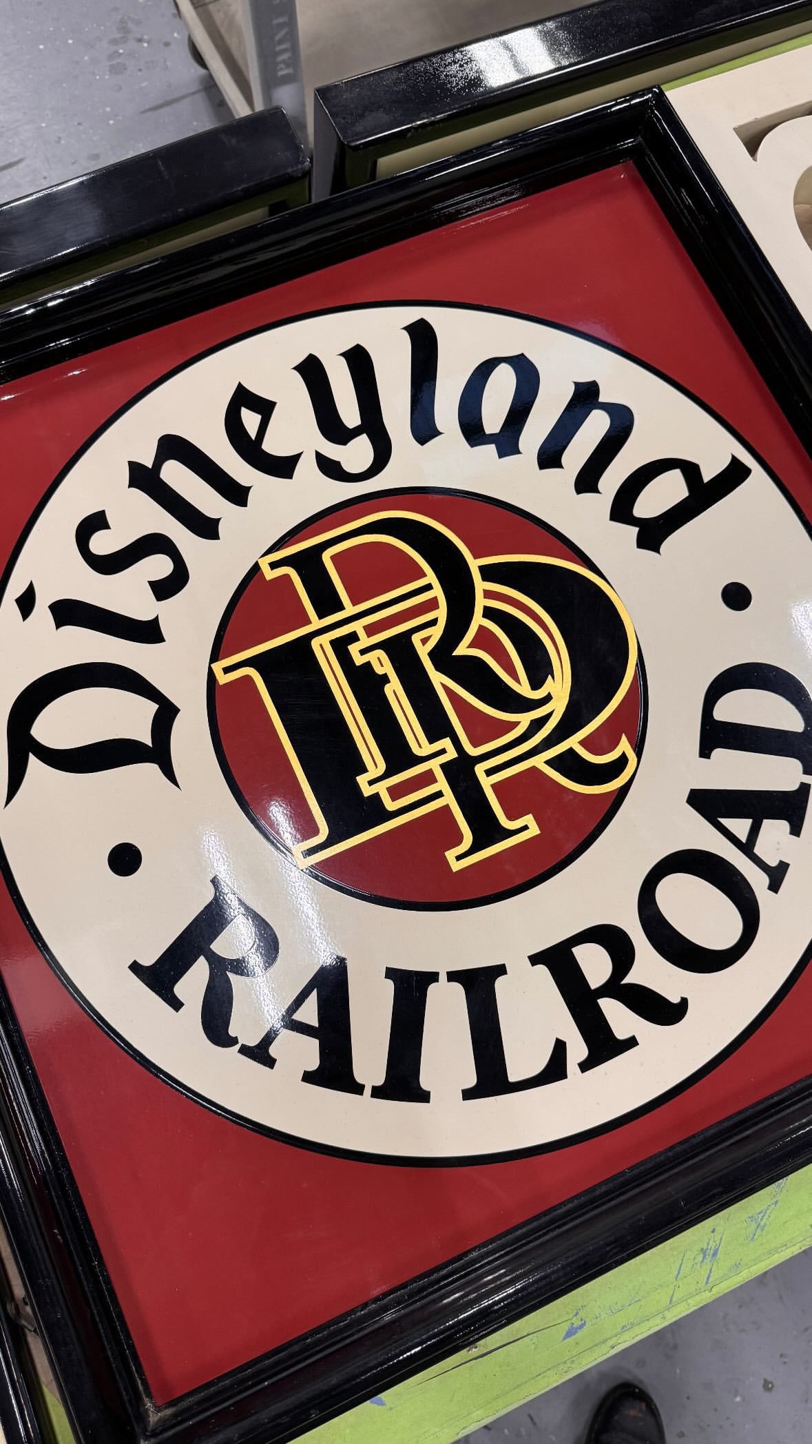 Hand-painted railroad herald sign in red, black and gold