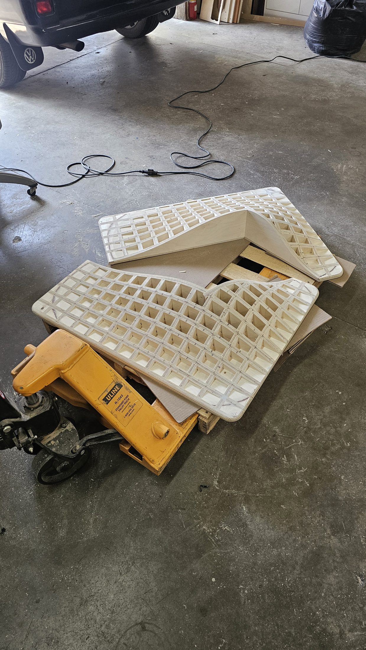 Carved foam panels stacked on a pallet jack