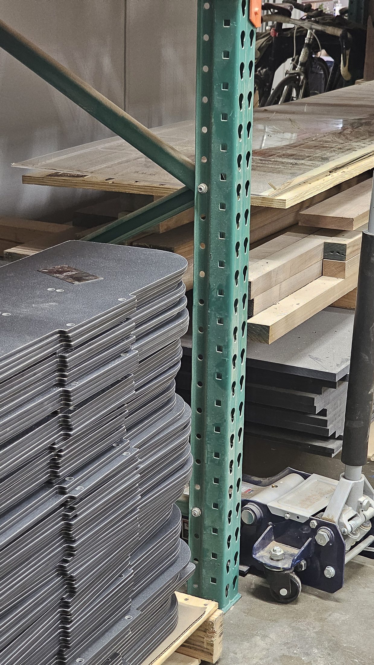 Stacks of routed dark panels on a rack