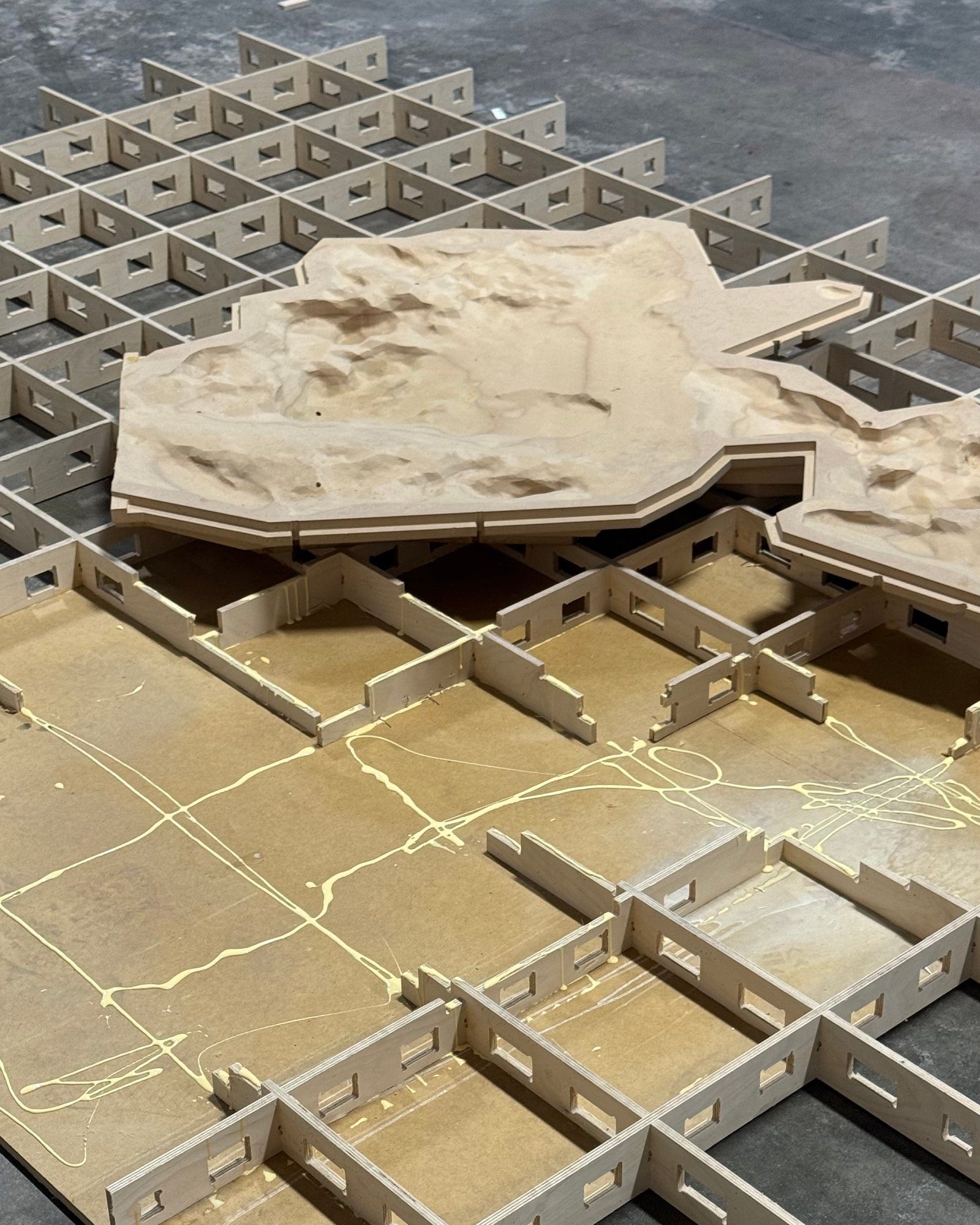 Slotted grid base supporting sculpted terrain forms