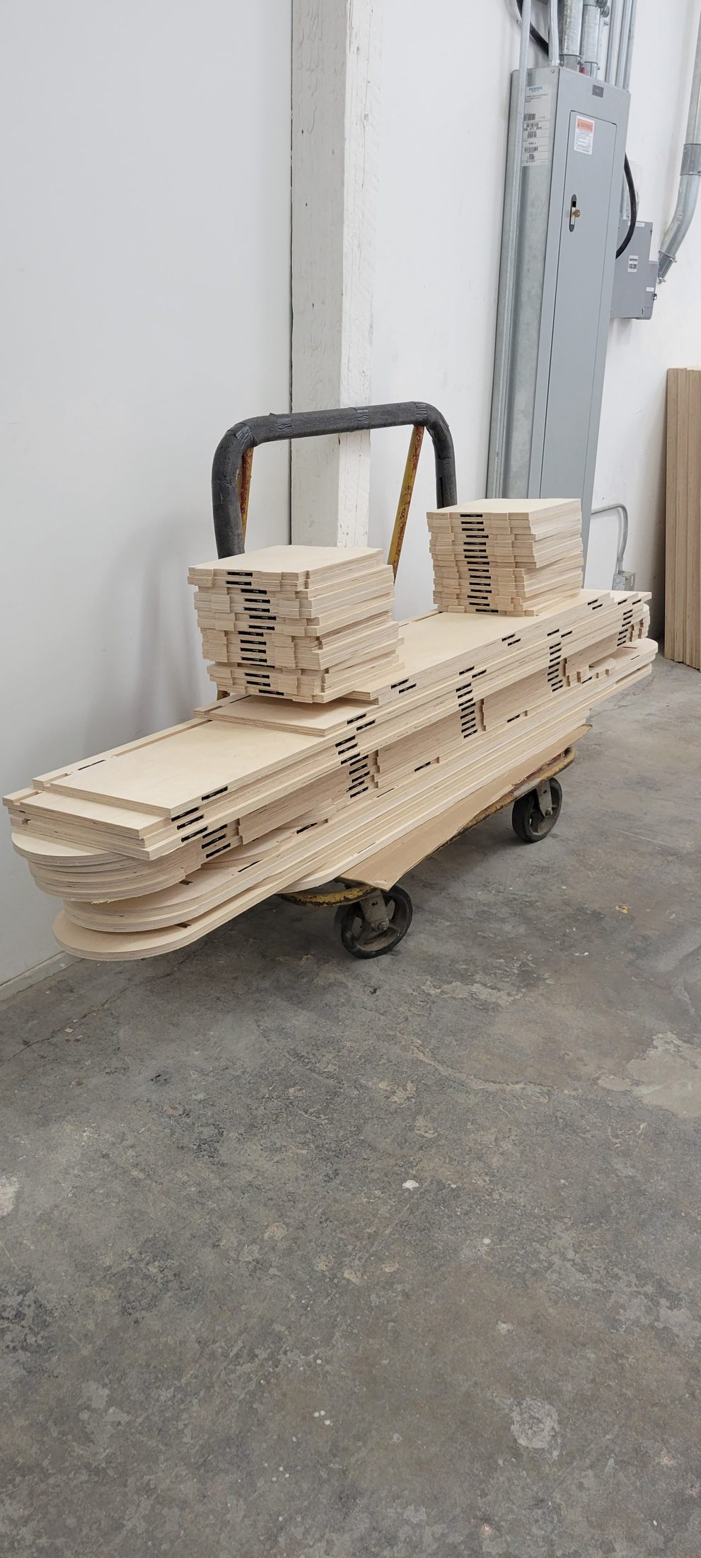 Routed plywood parts on a hand truck