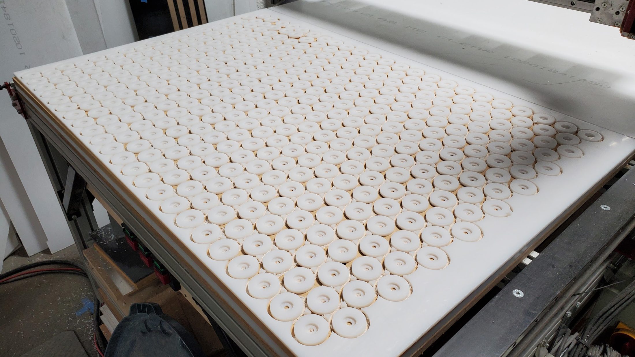 Rows of circular parts cut from a white sheet
