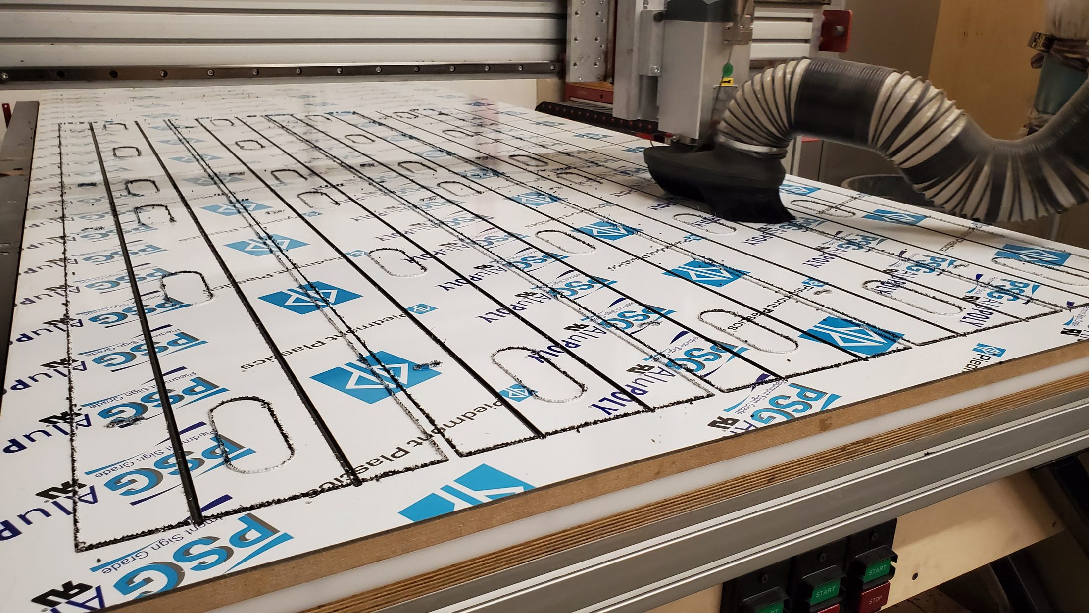 Acrylic sheet with protective film being routed