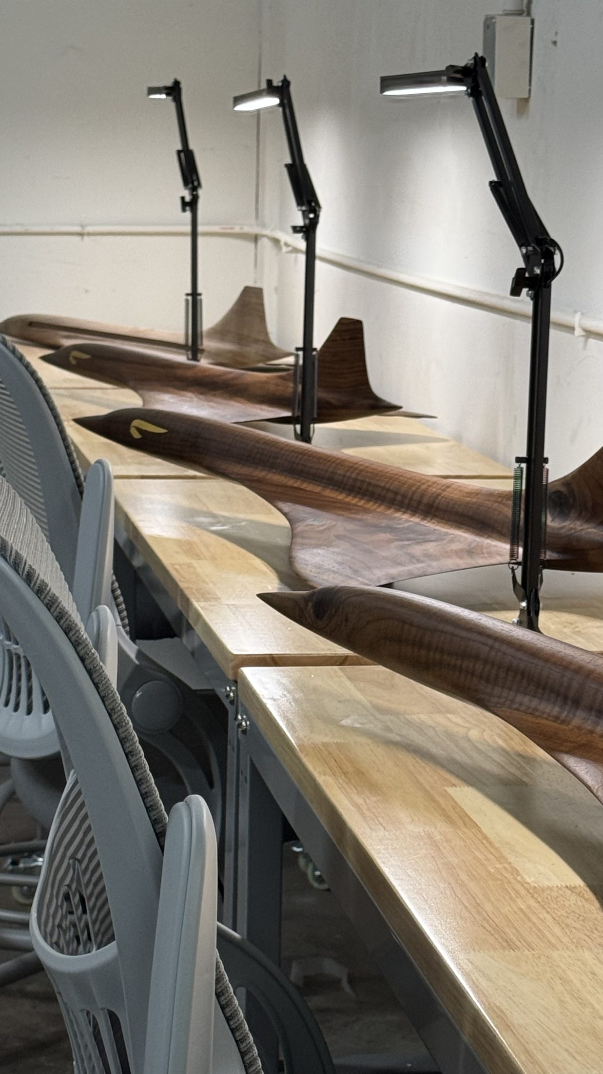 Carved wood aircraft models on a workbench
