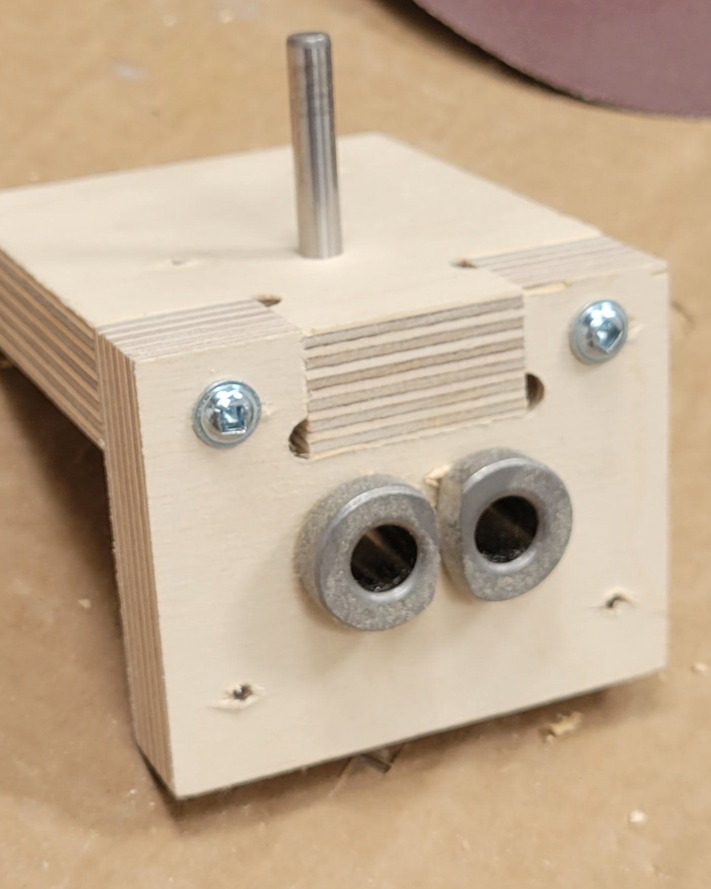 Plywood fixture block with inset bushings