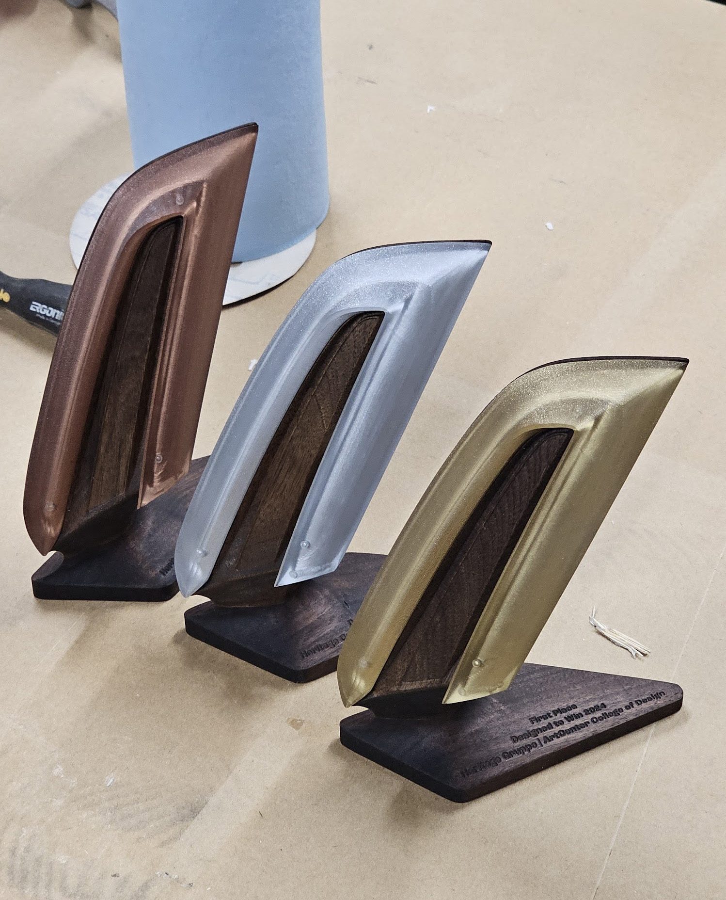 Three carved desk pieces in walnut, silver and gold finishes