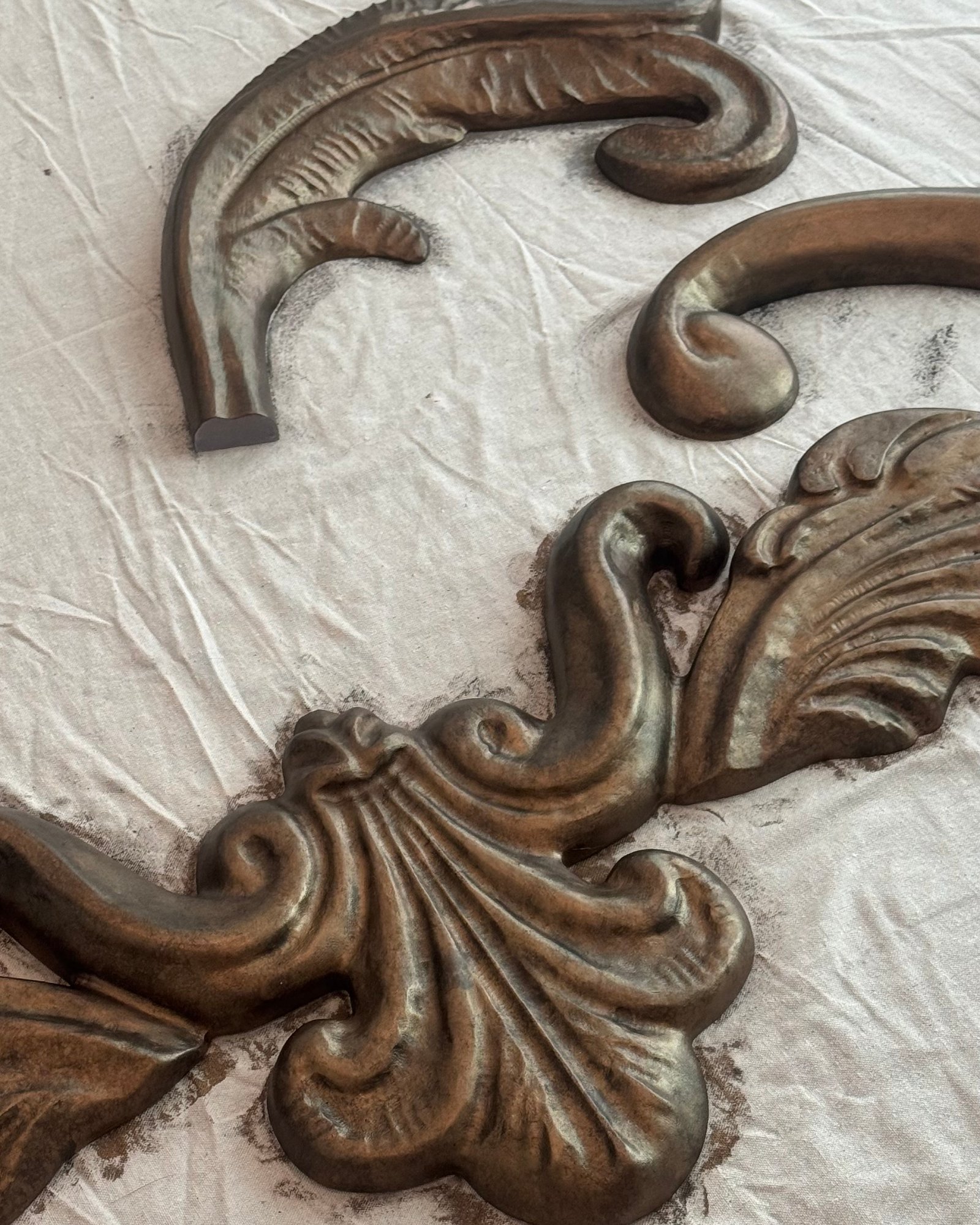 Cast ornaments with an aged faux bronze finish
