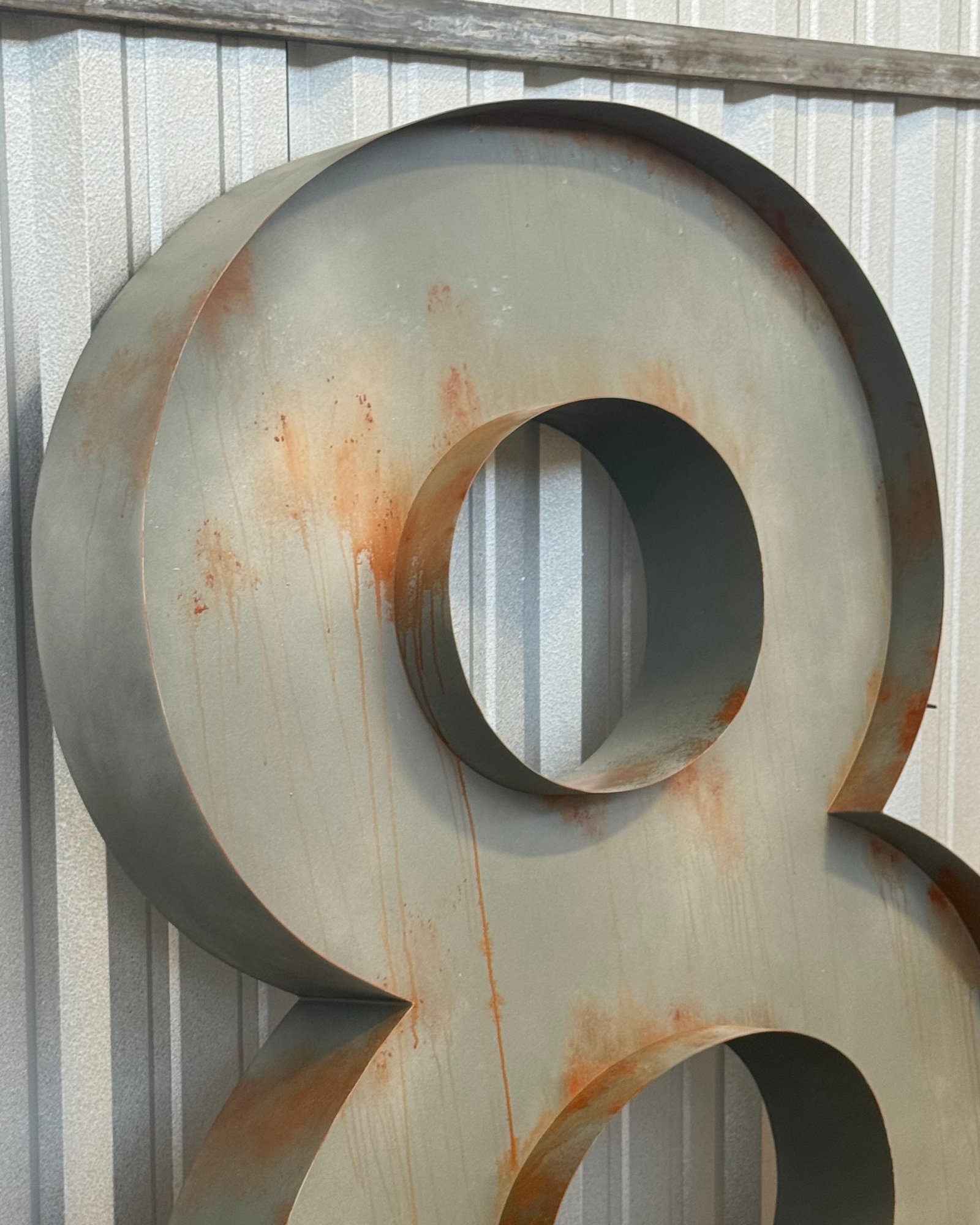 Oversized dimensional numeral with a faux rust and patina finish