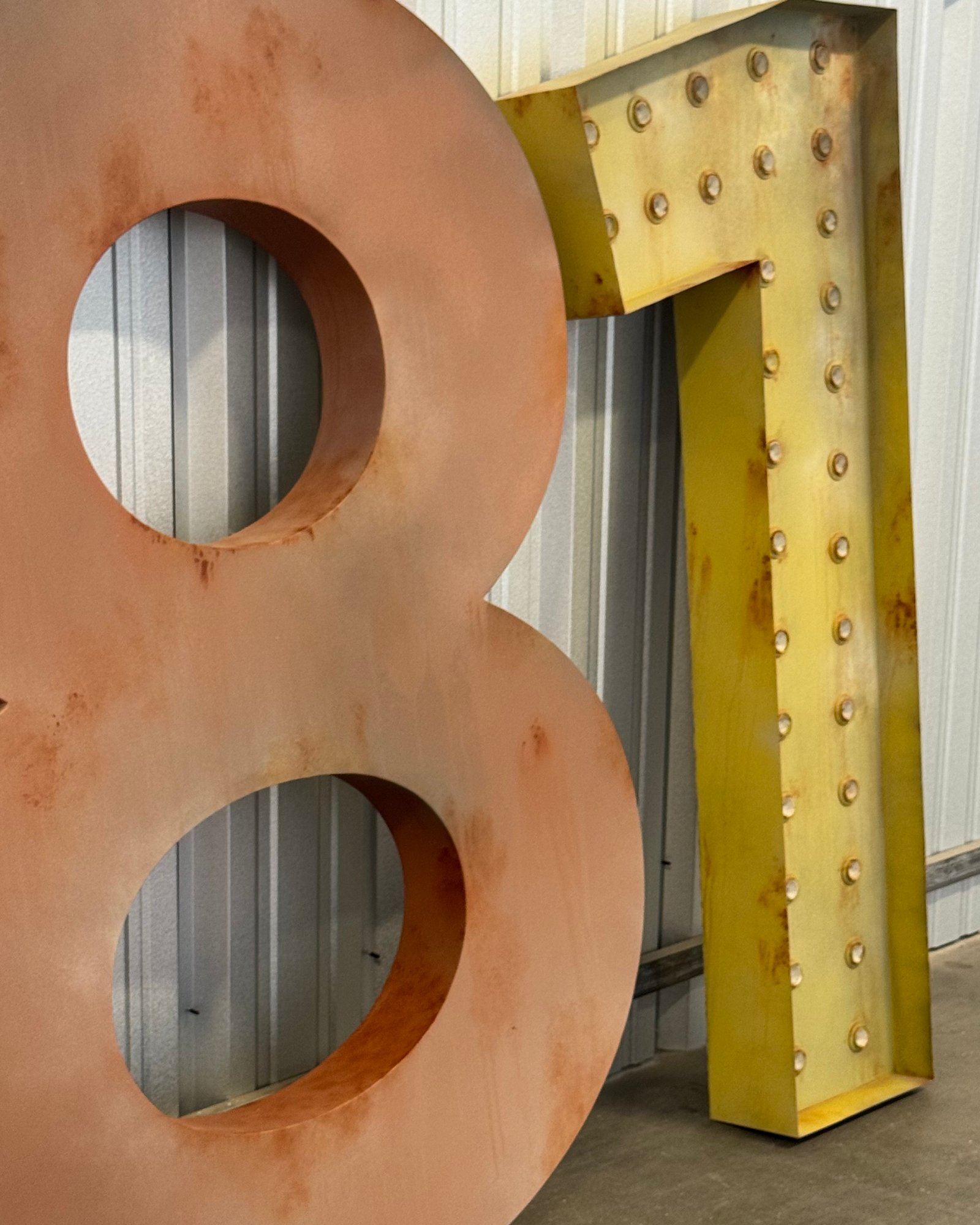 Oversized marquee numerals with aged copper and gold finishes