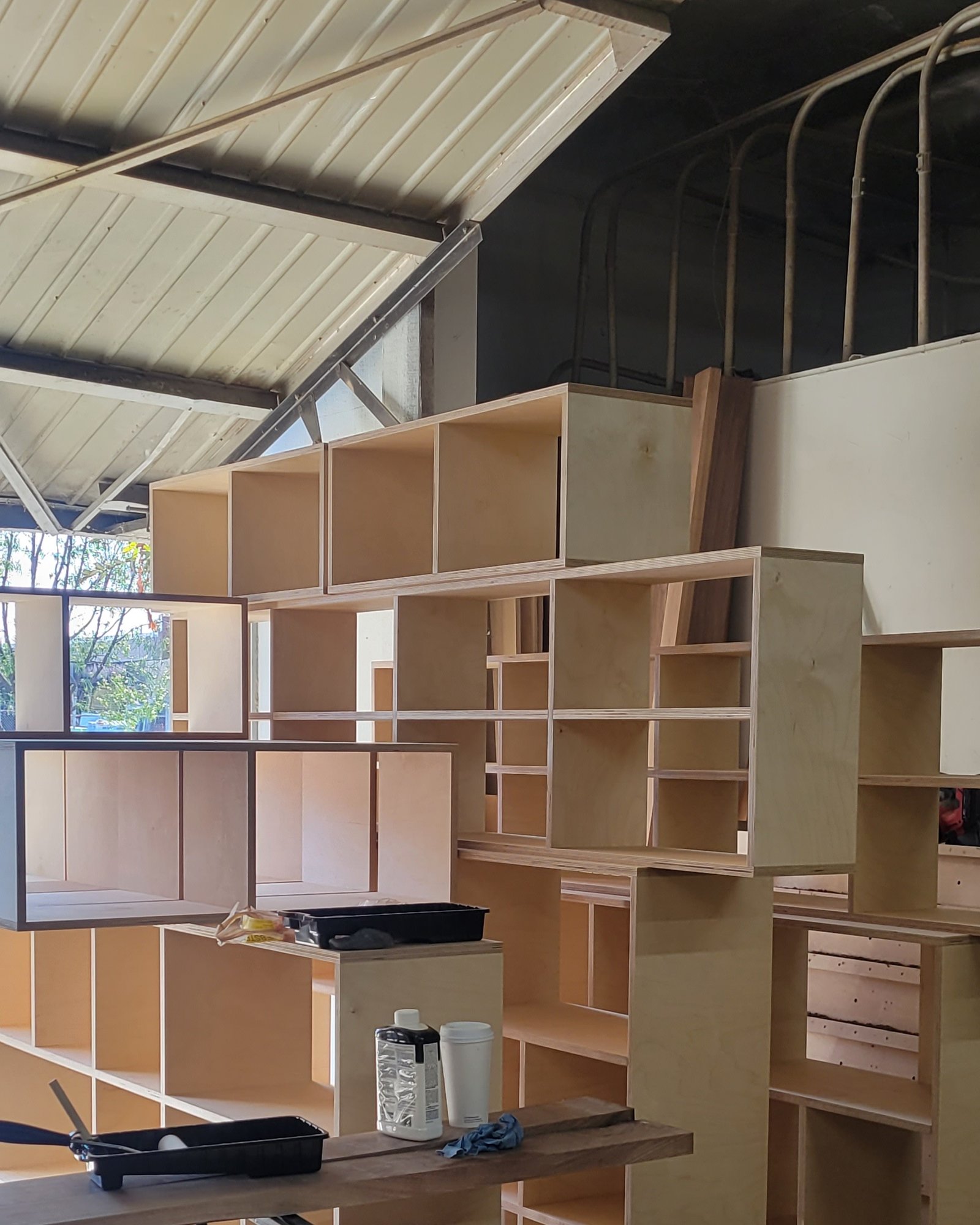 Plywood cubby shelving wall during assembly