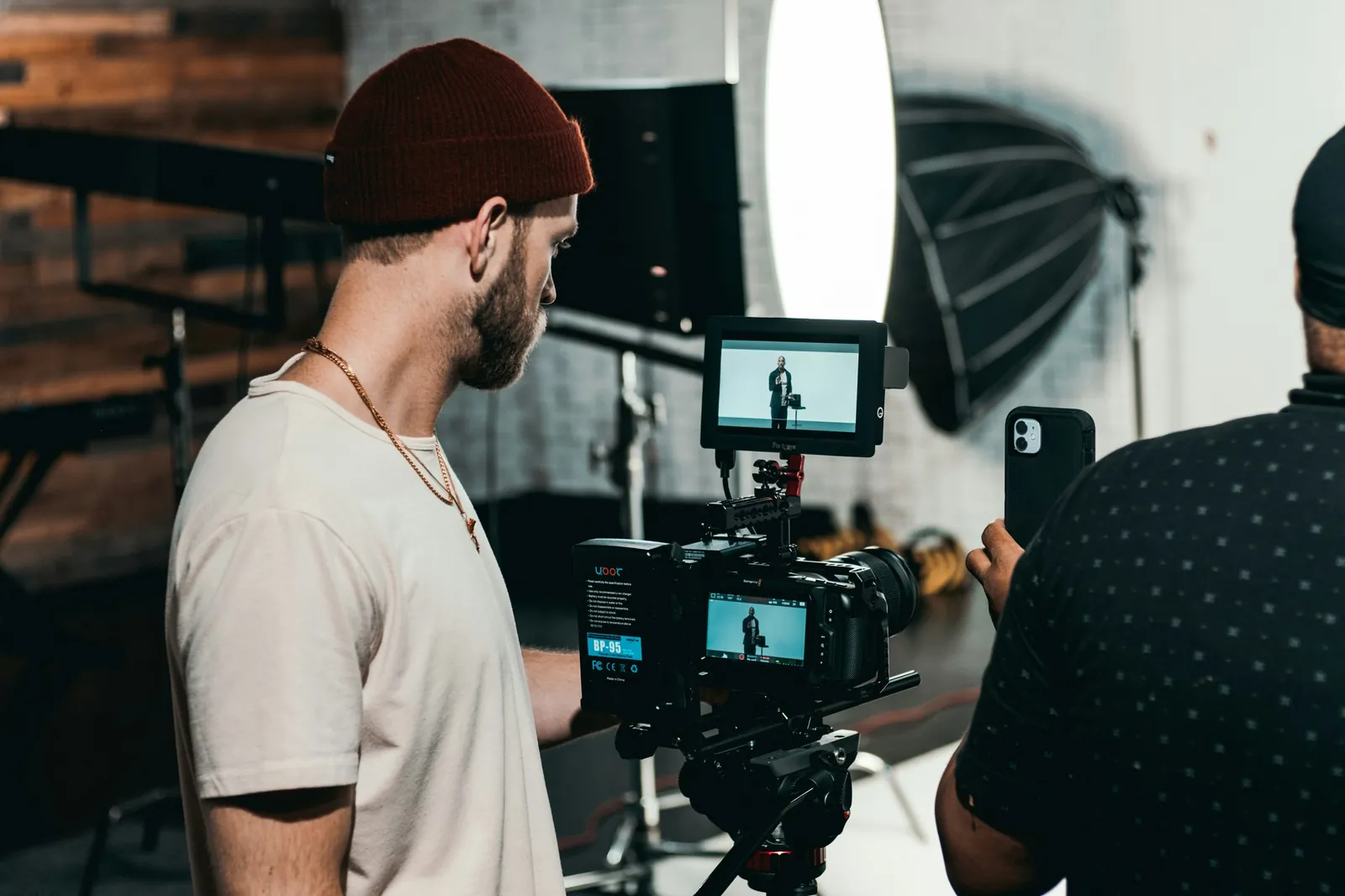Crew members reviewing footage on a camera monitor during a shoot