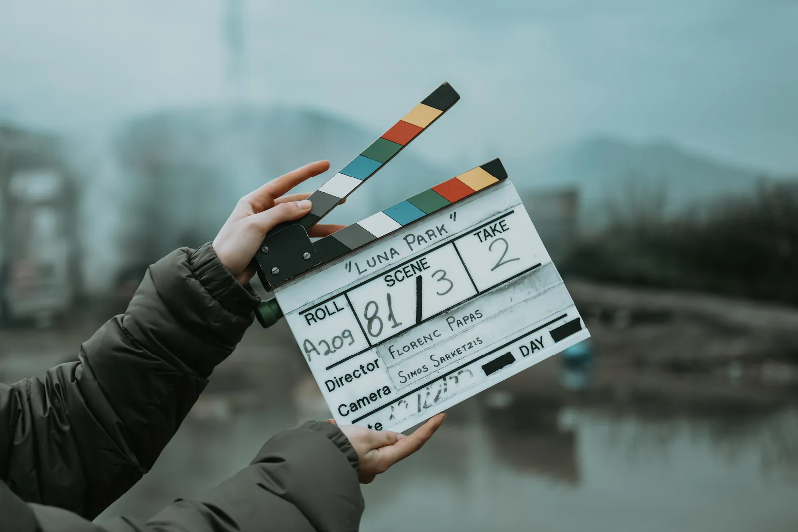 Camera assistant holding a clapperboard slate marked with scene, take and roll number