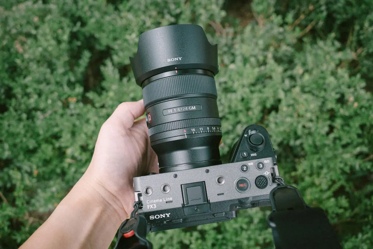 Sony FX3 Cinema Line camera held from above, fitted with a Sony FE 24mm f/1.4 G Master lens