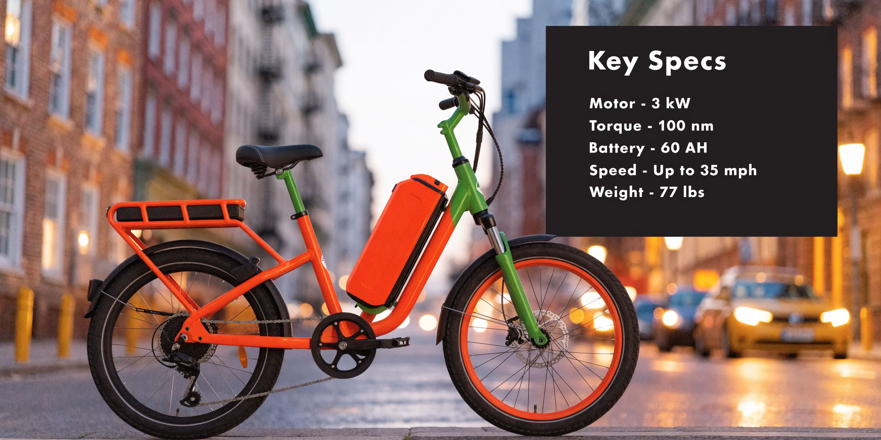 A bright orange and green electric bike with high-performance specs parked on a city street.