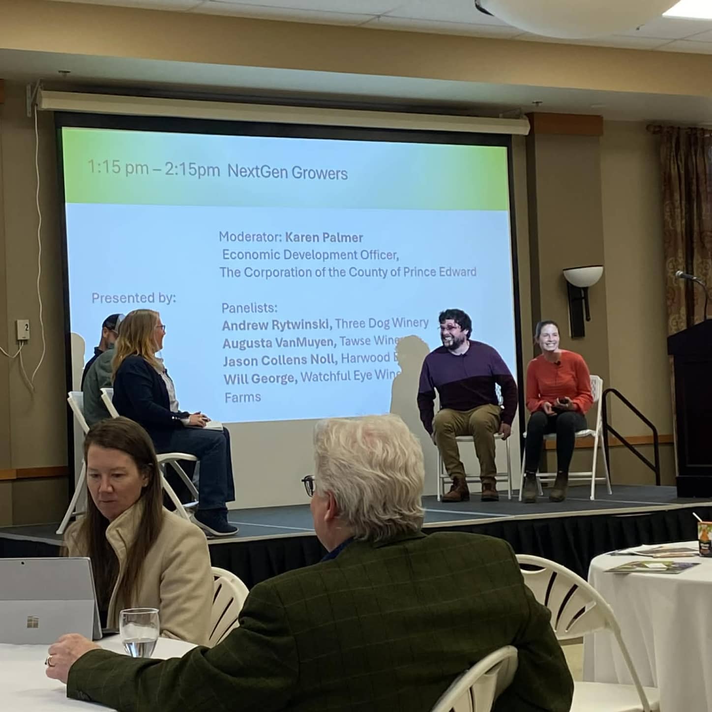 A table of people watching a presentation at Spring Tune Up
