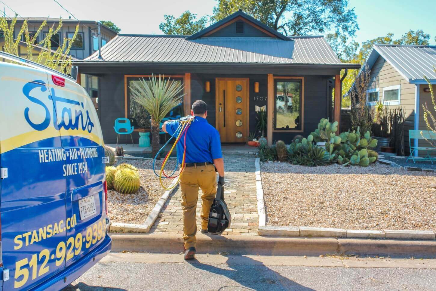 Stan's technician walking up to front door with tools and gear
