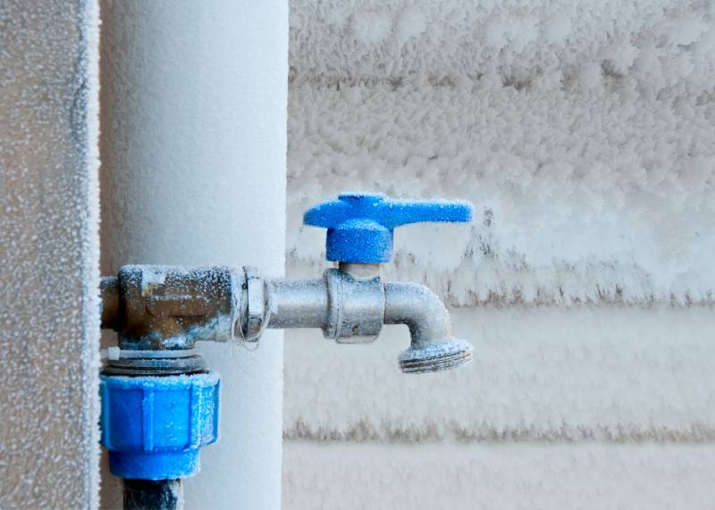 Frozen outdoor faucet with frost