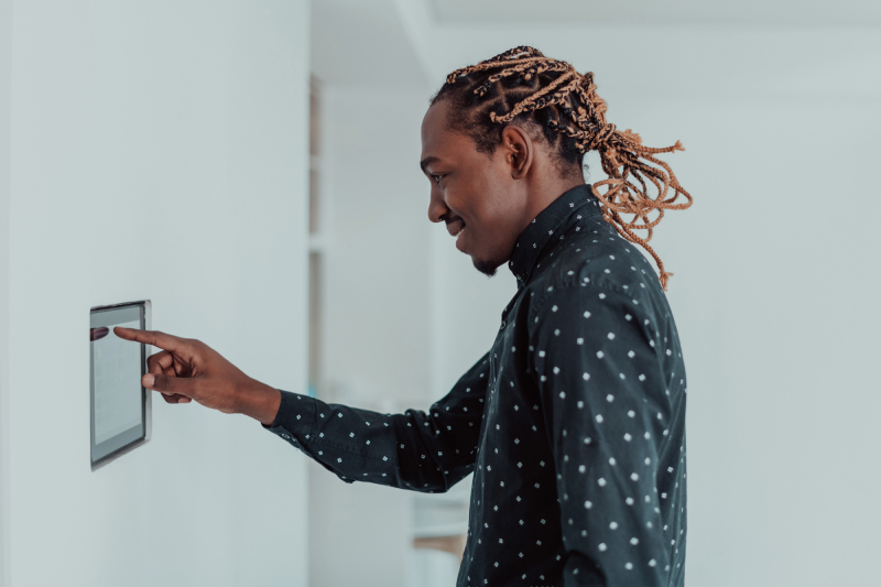 Man using touchscreen thermostat