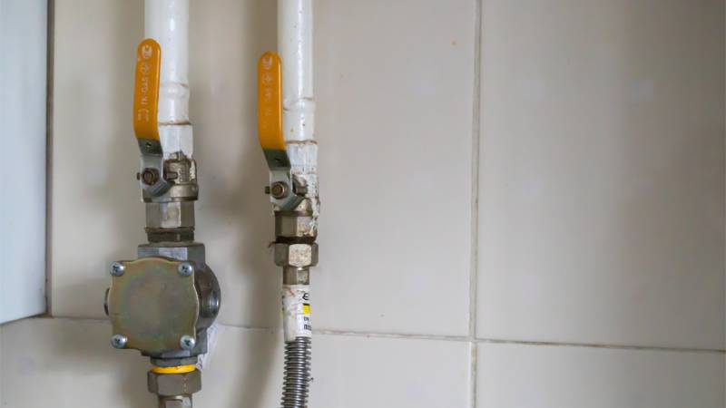 Gas valves on tiled wall