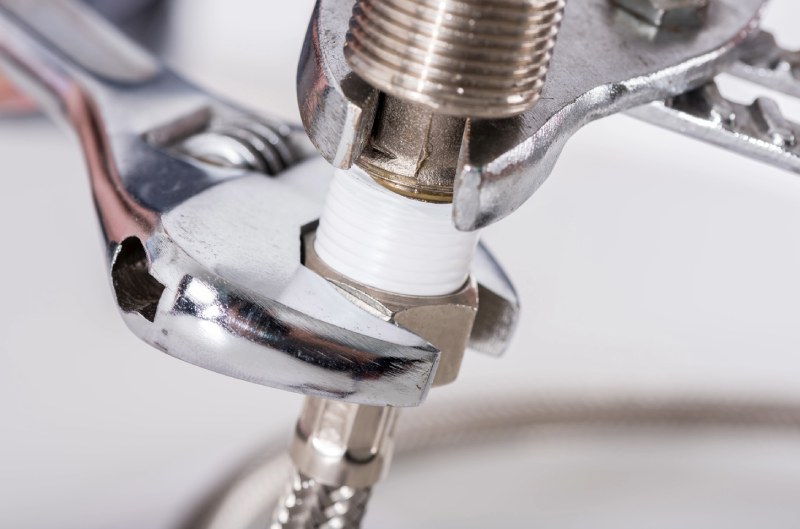 Wrench tightening plumbing fitting