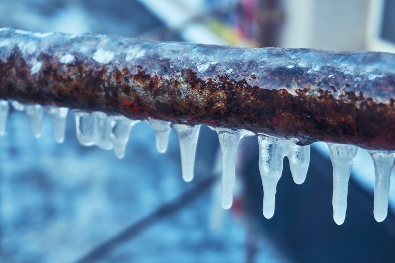 Frozen pipe with icicles.