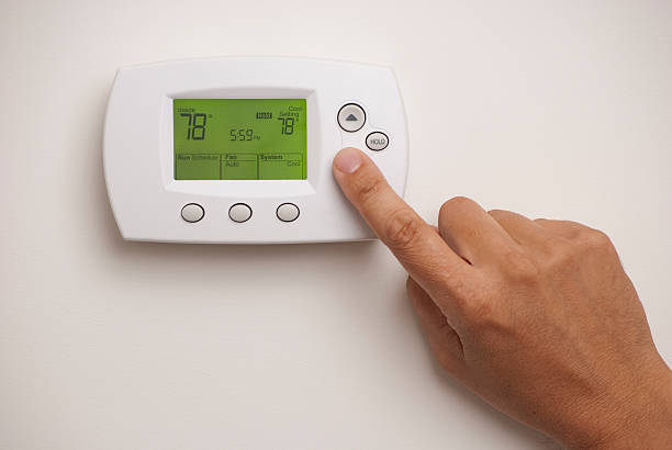 Hand adjusting wall thermostat.