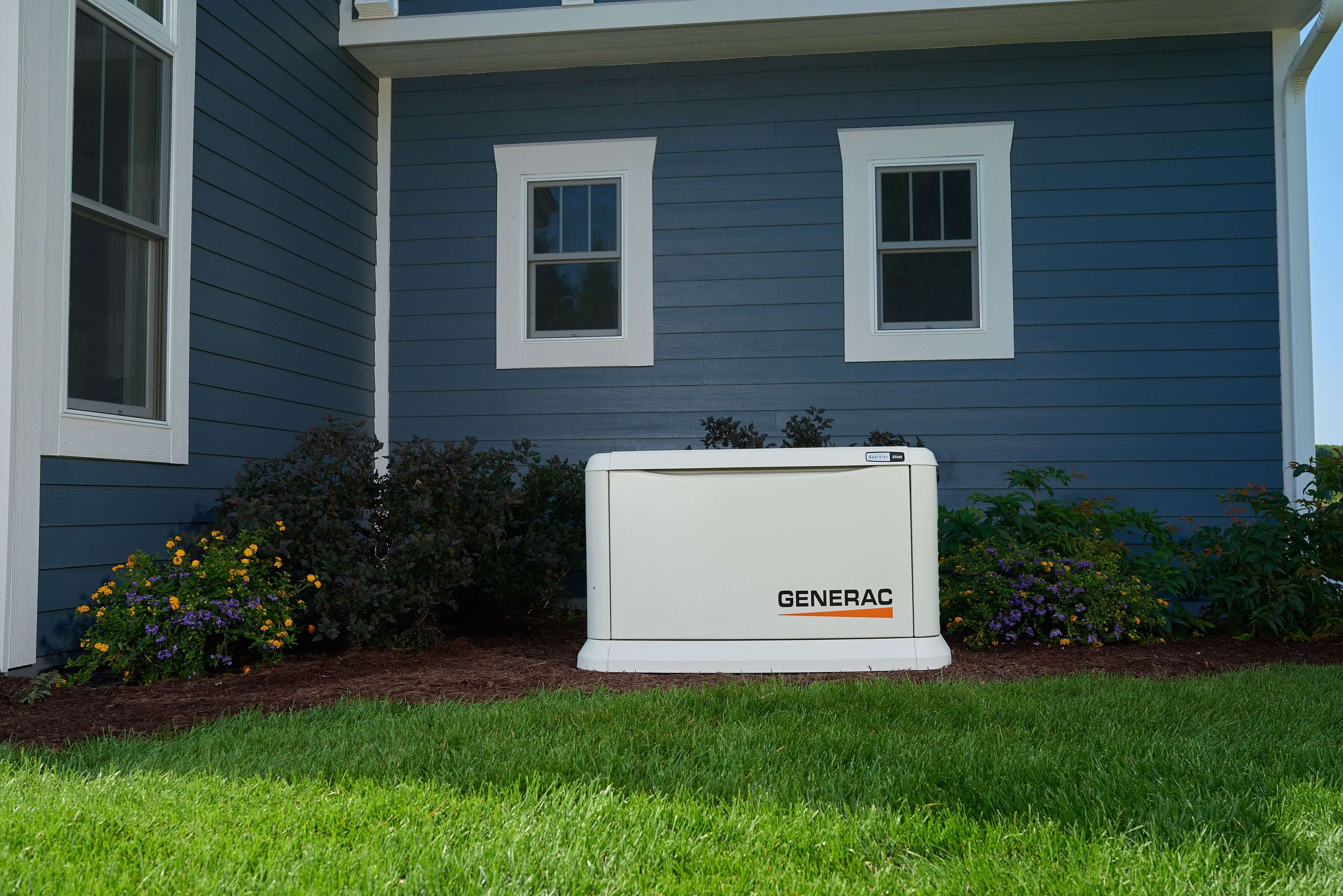 "Generac generator beside blue house"