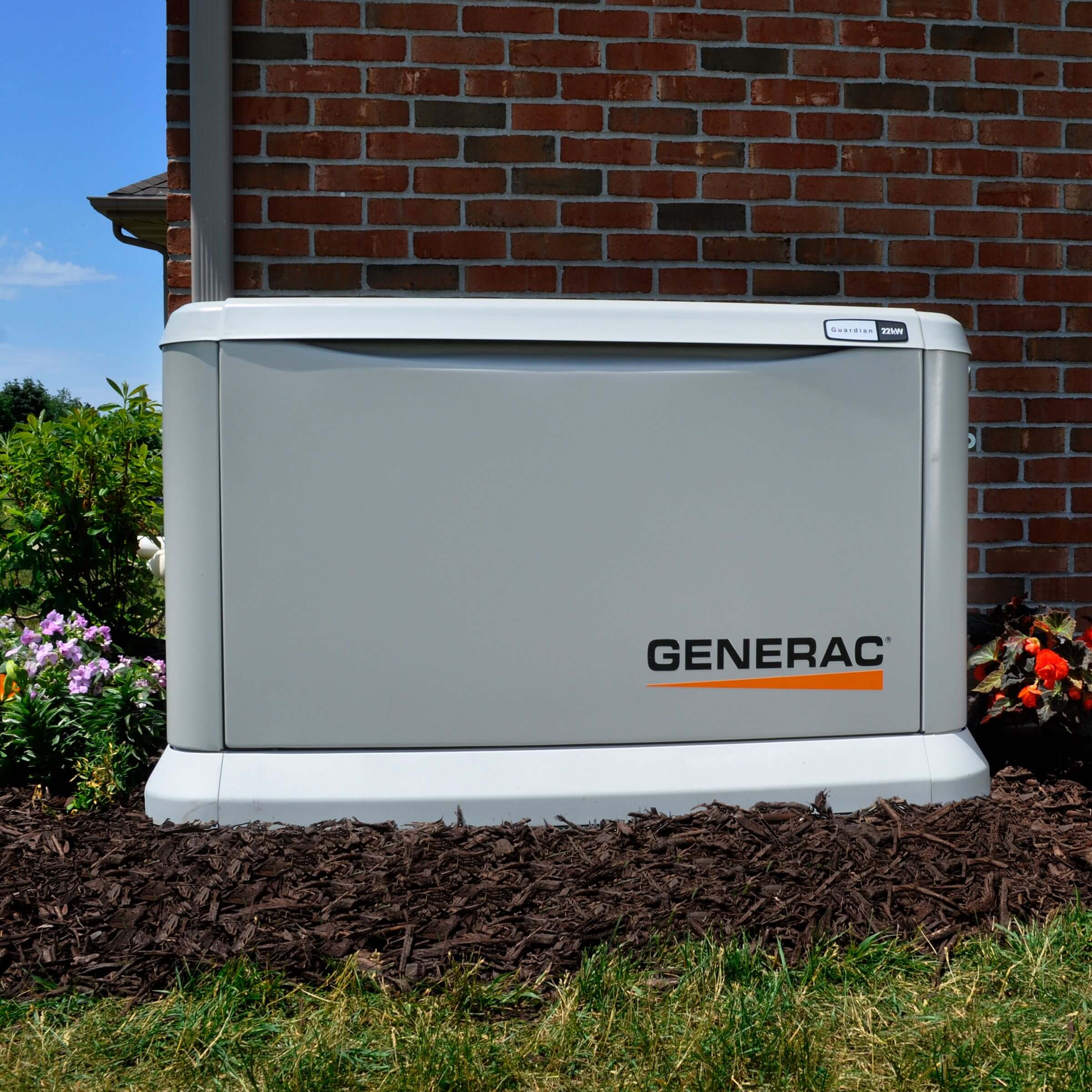 Generac generator beside brick house.