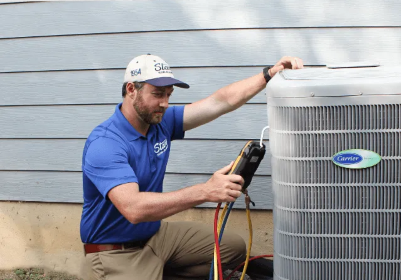 Technician inspecting AC unit.