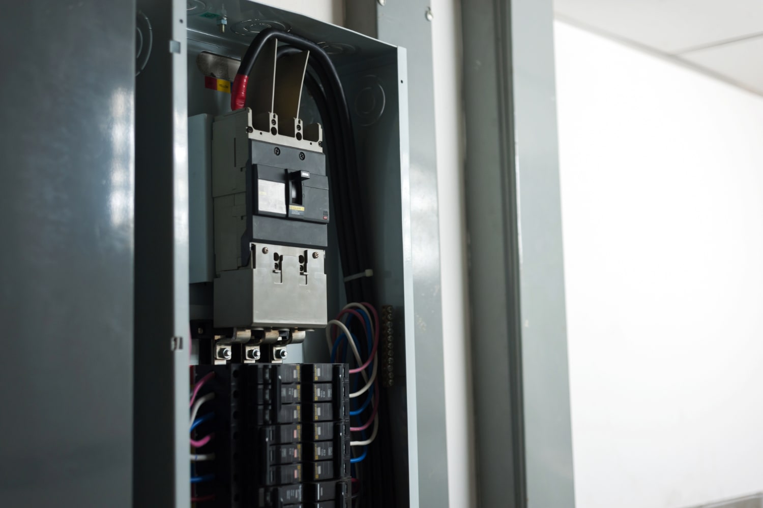 Electrical panel inside gray box.