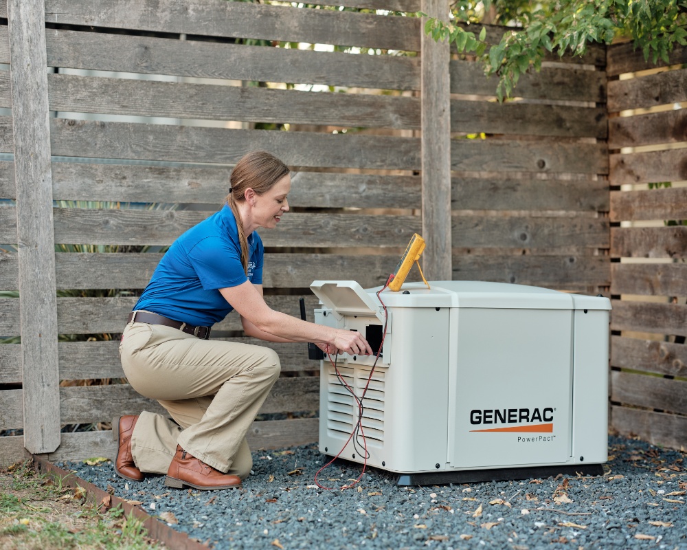 Technician checking Generac generator outdoors.