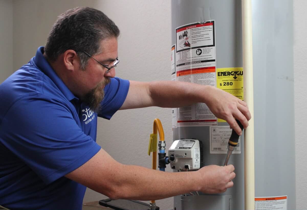 Technician flushing water heater.