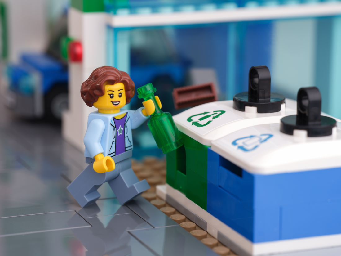 LEGO figure recycling a bottle