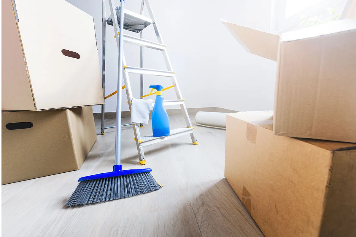 Professional move-out cleaning team scrubbing kitchen surfaces in a Dallas apartment for end-of-lease service
