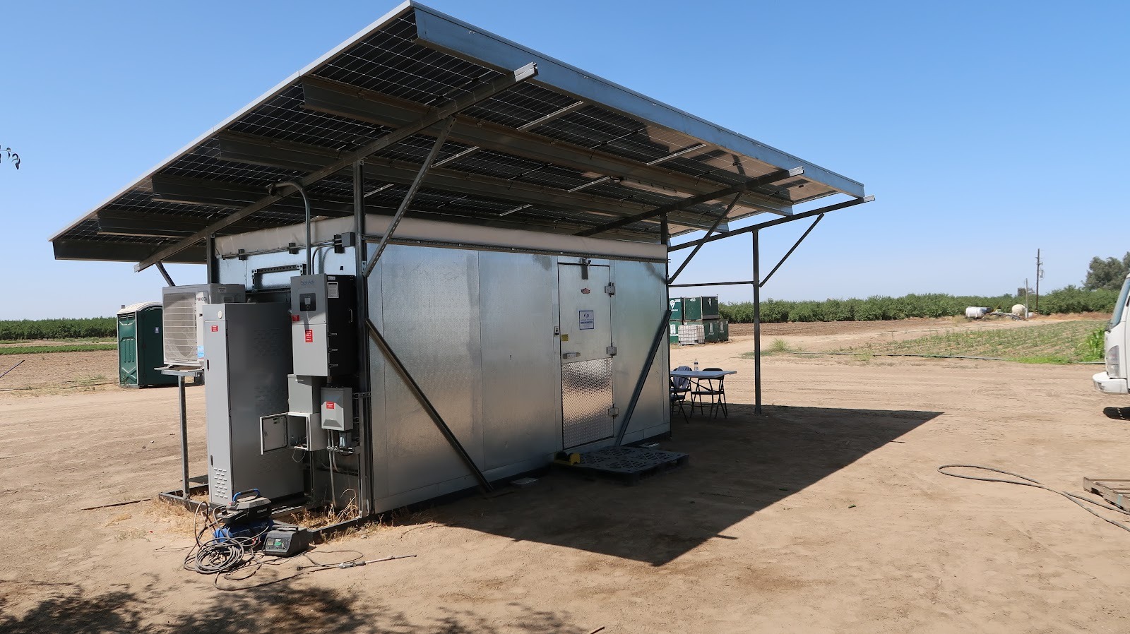 a constructed solarfresco cooler sits in a field on a sunny day