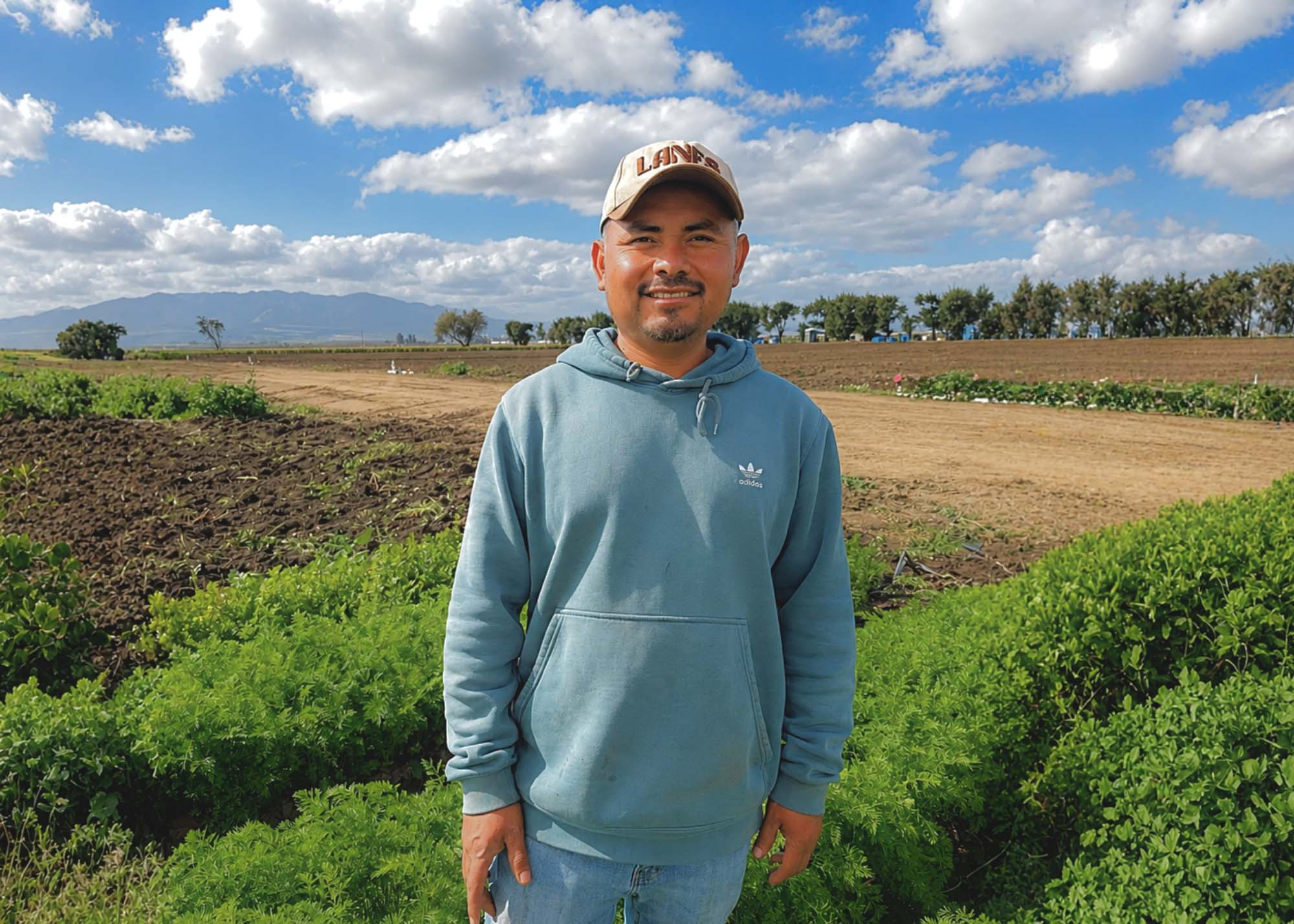 Jessie Najera standing in a field of crops