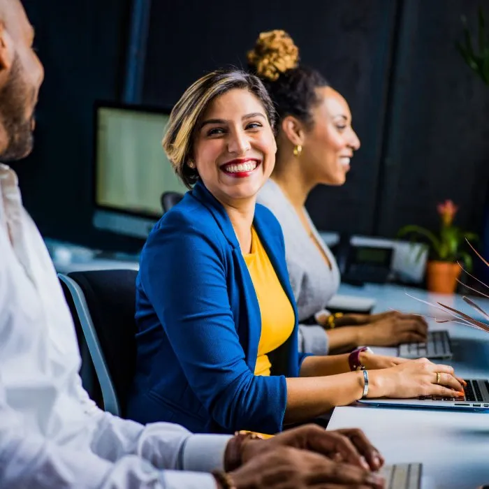 a woman smiles to her team, working together